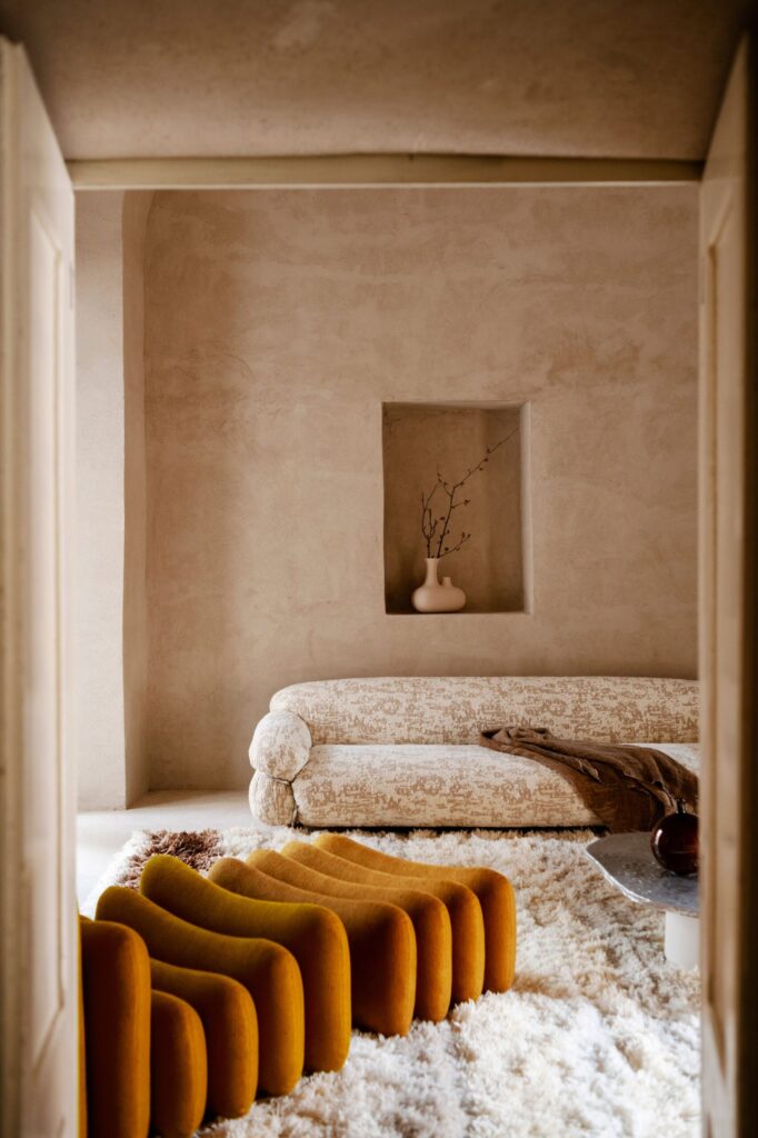 The Additional System armchair and it's futuristic, modular sophistication draws all the attention in this living room with hand-painted walls and shag carpet.