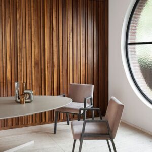 Split table has disarming simplicity, in a stylish wood paneled modern room.