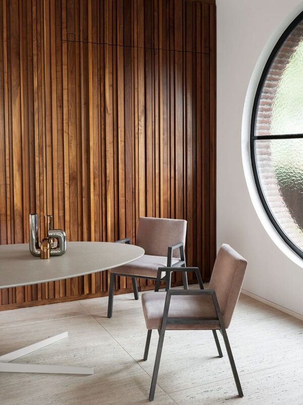 Split table has disarming simplicity, in a stylish wood paneled modern room.